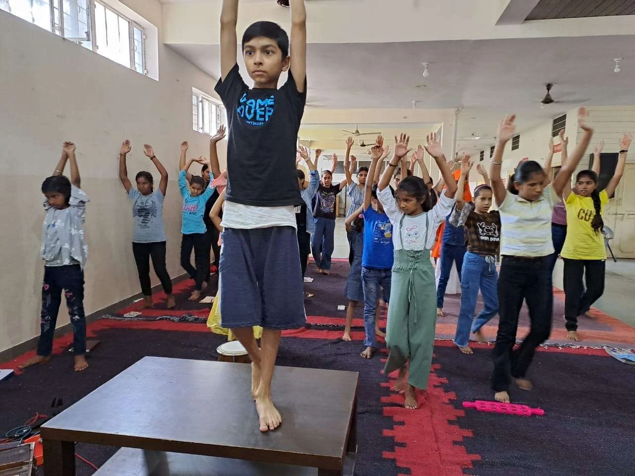 An indoor group yoga practice from the original RAWA gallery